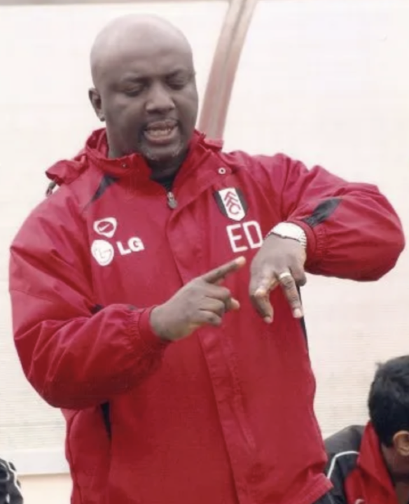 Eugene Dwaah as Talent Identification Manager at Fulham FC, wearing official club kit with his initials
