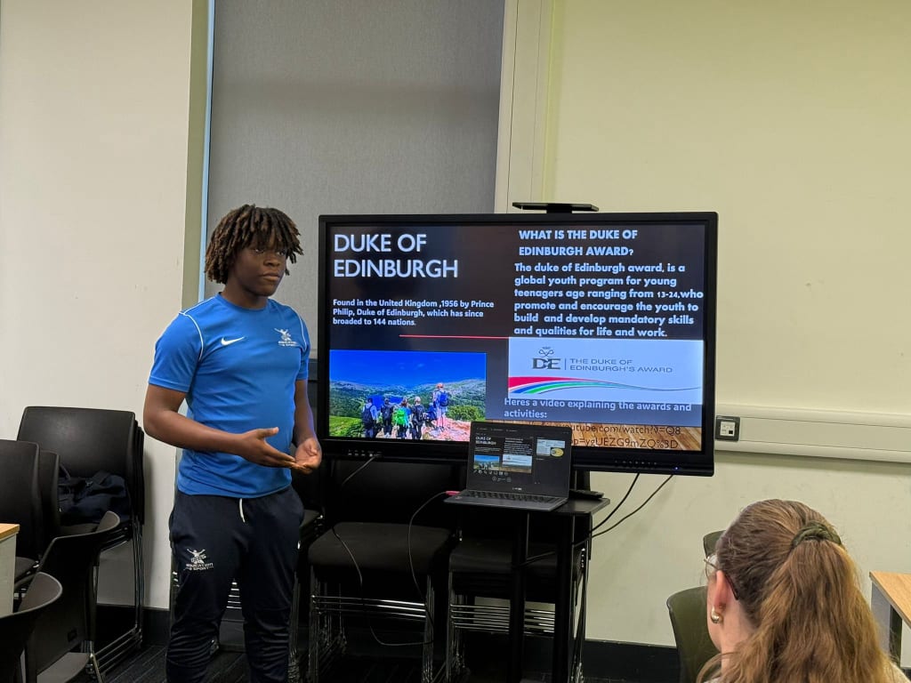 A student presenting about the Duke of Edinburgh Award to their peers